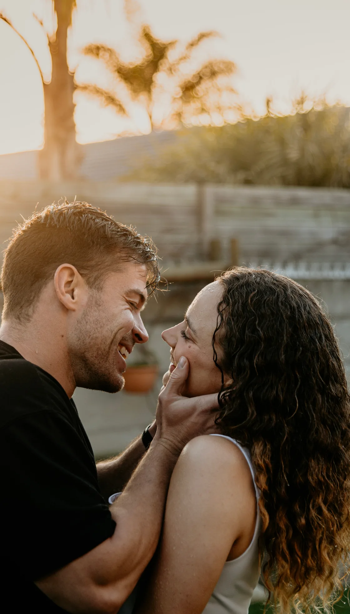 Anru and Leane laughing together, her face in his hands